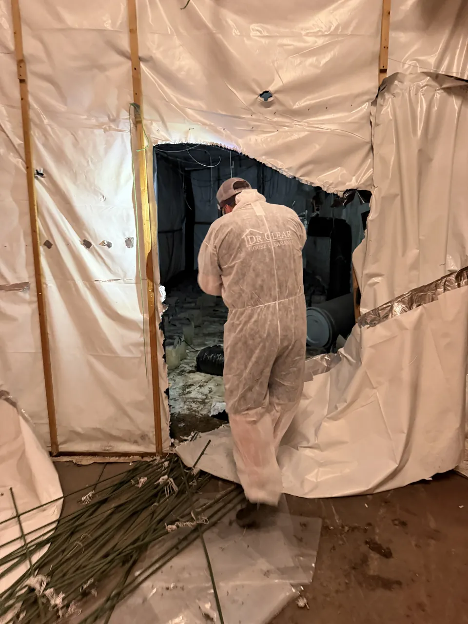 DrClear team member in protective overalls entering a cannabis farm grow tent in Coventry