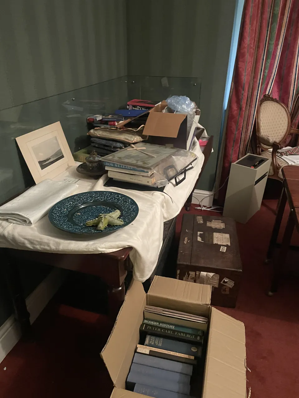DrClear team clearing an estate in Tamworth, Staffordshire, with books boxed up beside a dining table
